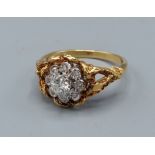 An 18ct gold diamond cluster ring, set with a central diamond surrounded by diamonds, 4.2gms, ring