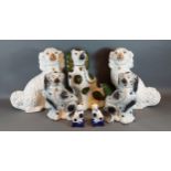 A pair of Staffordshire pottery dogs, 32cm tall, together with another pair of smaller dogs, a