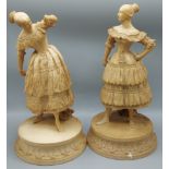 A pair of 19th Century Parian ware figures of two ladies waring lace dresses upon circular bases,