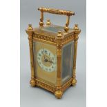 French brass cased carriage clock the enamelled chapter ring with Roman numerals, 13cm high