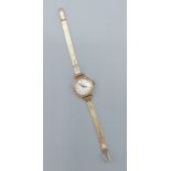 A 9ct gold ladies wristwatch by Record with 9ct gold strap, 14.8gms excluding movement