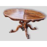 A William IV Rosewood centre table, the shaped top above a quadruple carved centre column upon