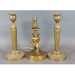 A pair of bronze Empire Style candlesticks with figural decoration, 21cms tall, together with a