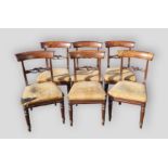 A set of six William IV rosewood dining chairs, each with a tulip carved rail back above an