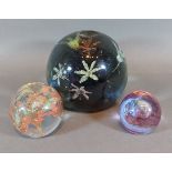 A large Victorian glass paperweight with flower head decoration, 11cms tall, together with a