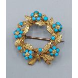 A yellow metal brooch in the form of a wreath set with Torquoise, 6.4gms