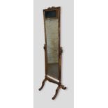 A French gilded Cheval mirror with reeded uprights and outswept legs with scroll feet, 178cms tall