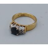 A 14ct gold Sapphire and diamond ring set with a central Sapphire flanked by eight diamonds, 4.9gms,