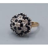 A 9ct gold diamond and sapphire cluster ring of tiered form, 4.9gms, ring size K