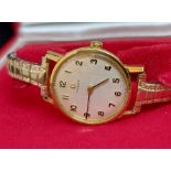 An 18ct gold cased ladies wristwatch by Omega, with replacement expanding bracelet and original box