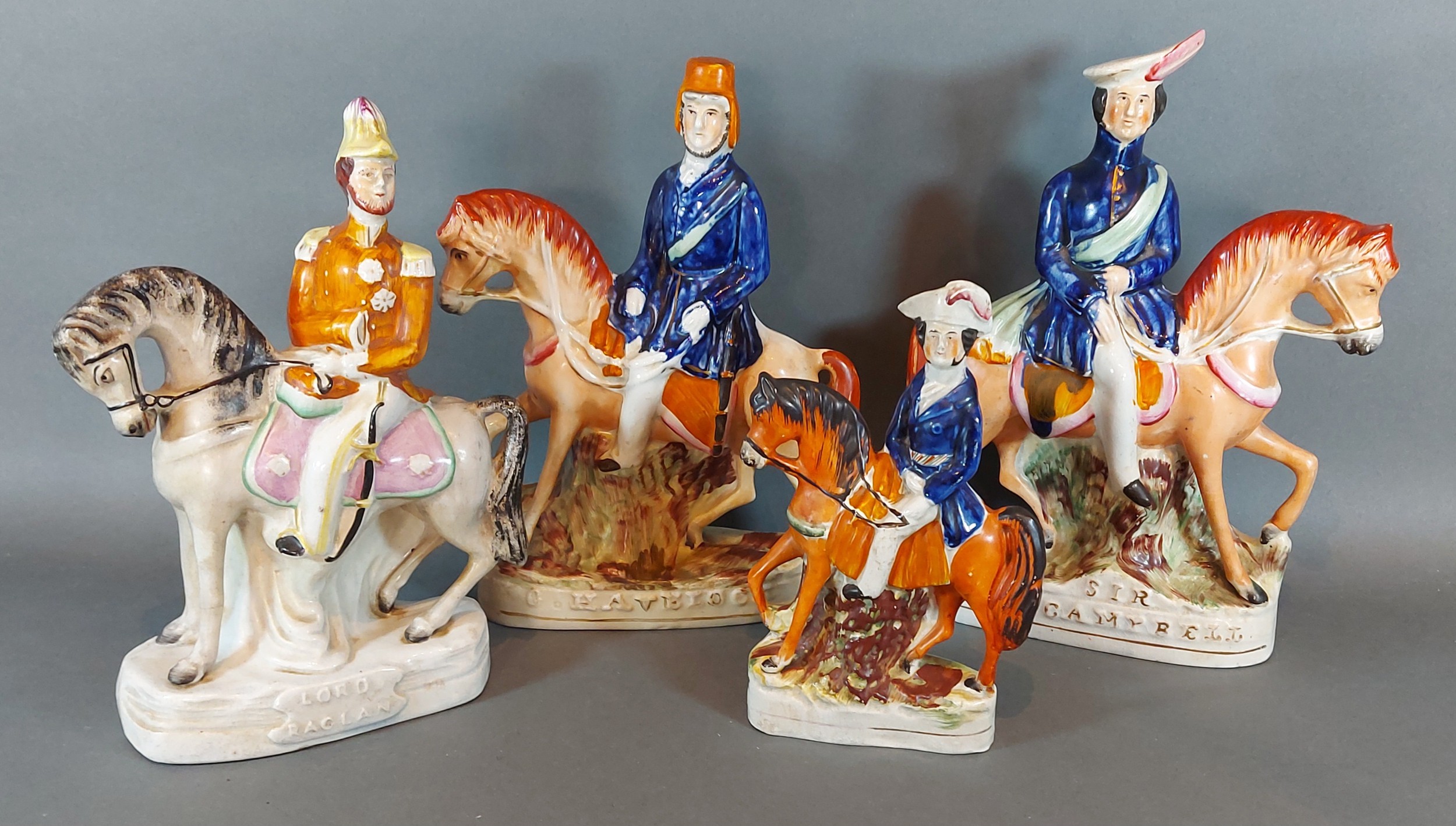A pair of Staffordshire pottery figures of Sir Colin Campbell and G Havelock upon horseback,