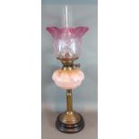 A Victorian Brass and glass oil lamp with opalescent glass bowl and cranberry glass shade, 54cm high