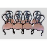 A set of eight ebonised balloon back dining chairs, with upholstered seats raised upon cabriole legs