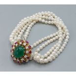 A five strand pearl bracelet, the large 18ct whit and yellow gold clasp with central cabochon