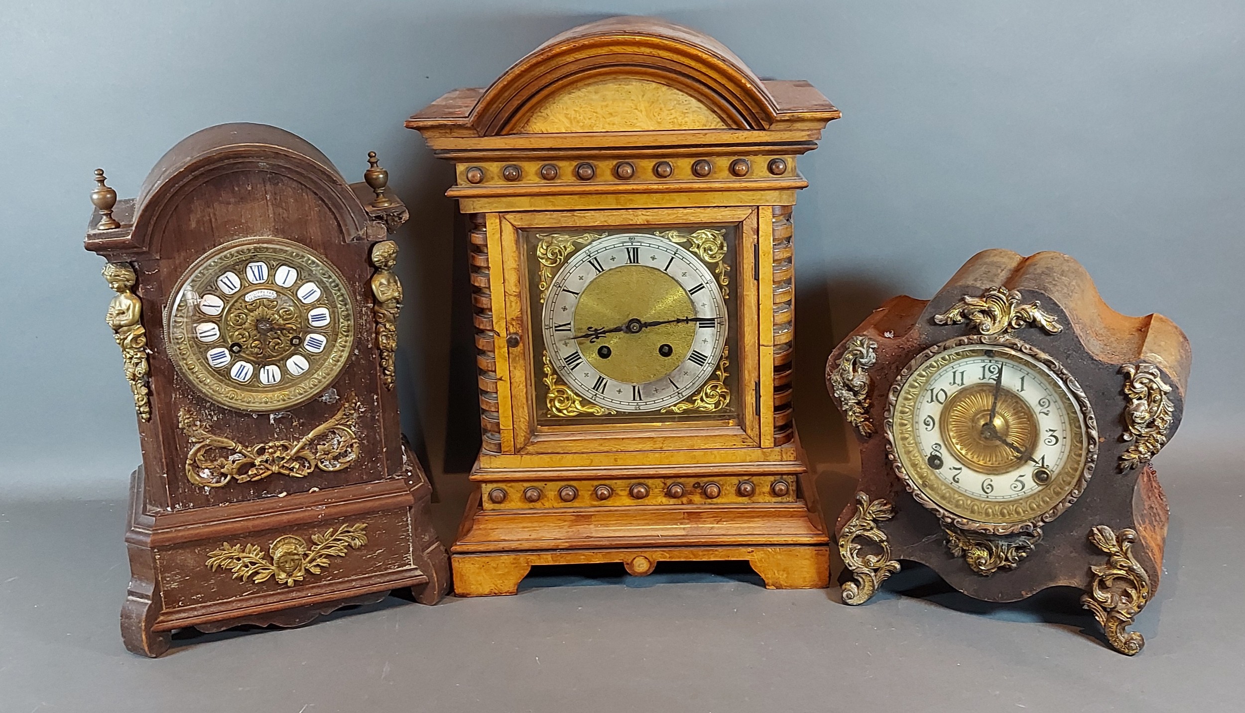 An early 20th Century walnut mantle clock together with two other mantle clocks