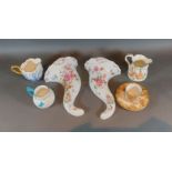 A pair of Royal Worcester porcelain wall pockets of conical form decorated with flowers, together
