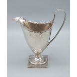 A George III silver cream jug of pedestal form, marks rubbed