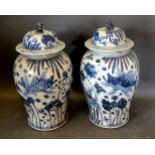 A Pair of Chinese Underglaze Blue Decorated Covered large Vases, the covers with dogs of fo surmount