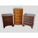 A pair of mahogany four drawer bedside chests together with a walnut chest of five drawers