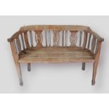 A teak garden bench with curved priced splat back, 113cms by 49cm and 73cms high