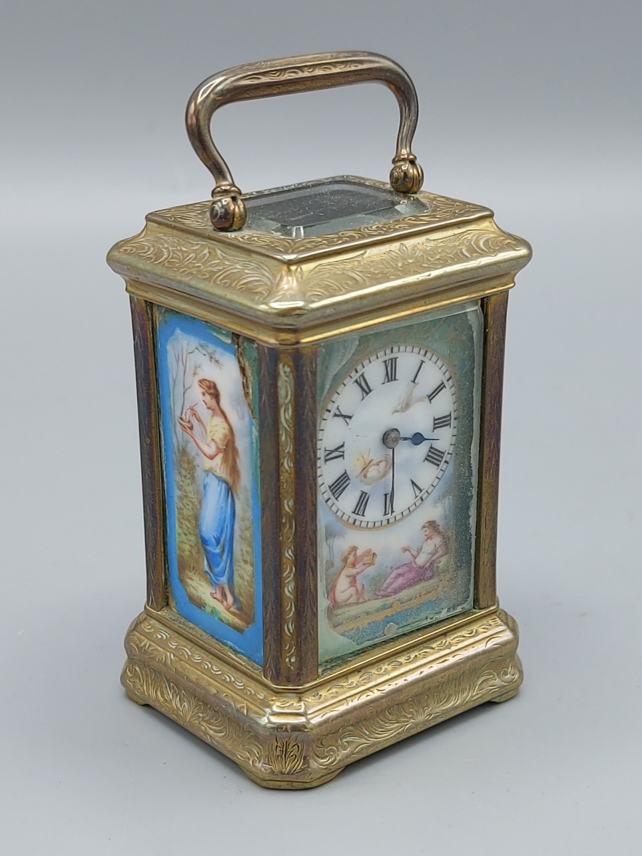 A French brass cased miniature Carriage clock with porcelain panels, lever escapement and carrying