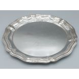 An 800 mark silver tray of shaped outline, 28ozs, 30cms diameter
