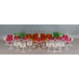 A Bohemian glass drinking set comprising coloured and clear glasses
