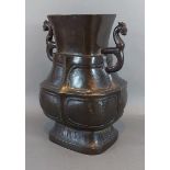 A Chinese patinated bronze two handled vase, 28cms tall