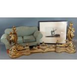 A brass fire fender in the rococo style together with a framed etching and a miniature sofa