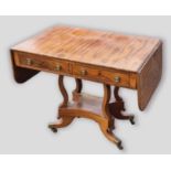 A Regency mahogany sofa table, the drop flap top with two frieze drawers opposed by dummy drawers