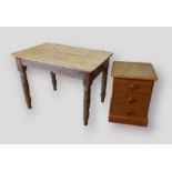 A pine farmhouse kitchen table, the plank top raised upon turned legs, 98cms wide by 64cms deep