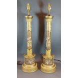 A pair of Toleware table lamps, each with gilded decoration with figures upon a mustard ground,