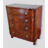 A Regency mahogany semi bow fronted chest of four long drawers with oval brass handles raised upon