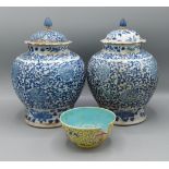 A pair of 19th Century Chinese covered vases decorated in under glazed blue foliage, four