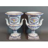 A pair of De La Reine porcelain two handled vases, hand painted with summer flowers and