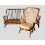 An Ercol stick back sofa together with a matching armchair