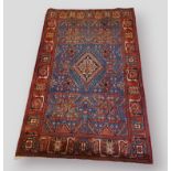 A Northwest Persian woollen rug with a ce ntral medallion within an all-over design within