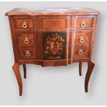 A French style inlaid chest, the moulded line inlaid top above three marquetry inlaid drawers with