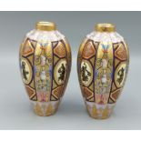 A pair of Viennese porcelain vases of ovoid ribbed form, each decorated in coloured enamels and
