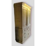 A 19th Century painted pine linen press, the moulded cornice above two doors enclosing trays, the