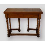 A rectangular side table, the hinged top above six turned legs with stretchers, 97cms wide, 38cms