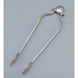 A pair of early 18th Century hinged silver sugar tongs by Samuel Hitchcock