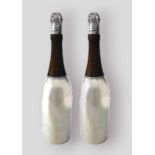 A pair of silver plated and wooden cocktail shakers in the form of champagne bottles, 37cms tall