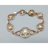 A 9ct gold bracelet in the form of flower heads set with pearls, 17.5gms