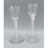 A 18th Century cordial glass with air twist stem, 15cms tall together with another air twist stem