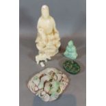 A carved soapstone figure of Guan Yin, together with four other carved stone items