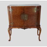 A Circa 1920's Queen Anne style walnut side cabinet by Maple and Co. The two doors with pierced