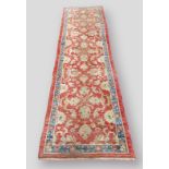 A North West Persian woollen runner with all over design within multiple borders upon a blue an