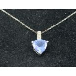 An 18ct white gold Tanzanite and diamond set pendant of heart form together with a fine linked chain