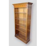 A mahogany narrow bookcase with moulded cornice above an inlaid freeze and four adjustable shelves